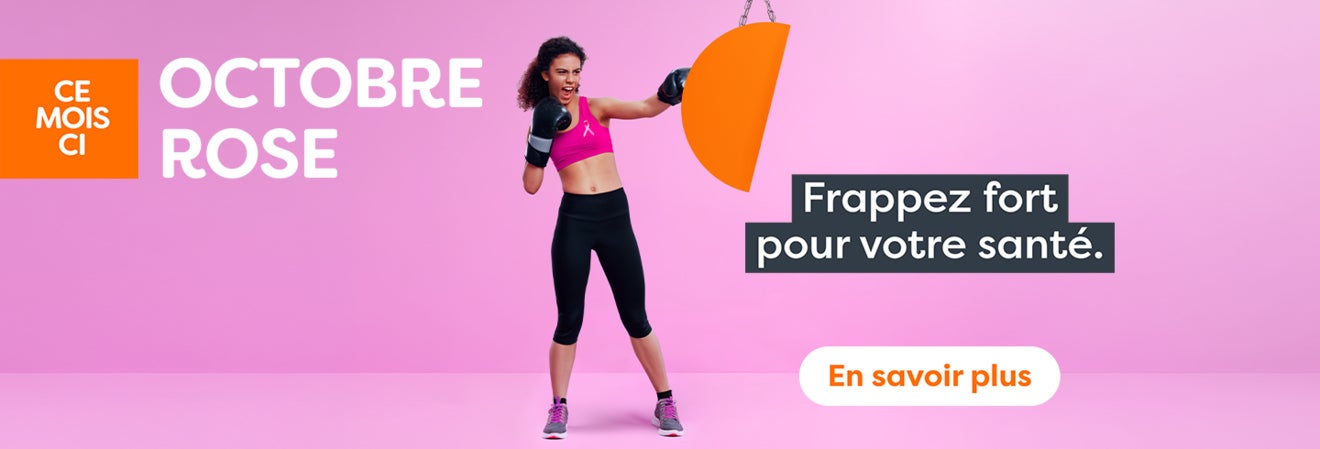 Octobre Rose – une femme frappe un sac de boxe. Frappez fort pour votre santé.